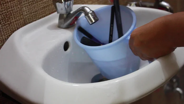 Gently squeeze out excess water from bristles (avoid pulling or tugging).