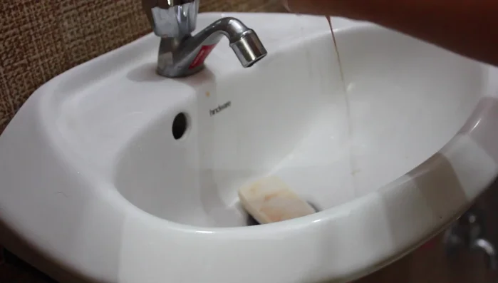 Rinse thoroughly under running tap water, rubbing on hands to remove all lather.