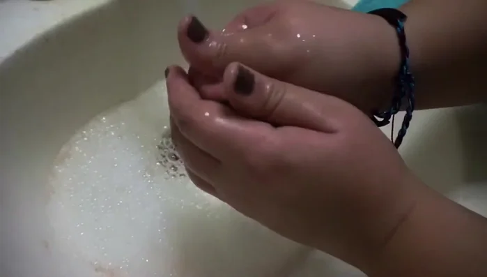 Add baby shampoo and gently swirl it in your hands, squeezing out excess water.