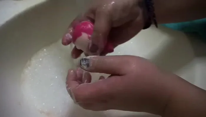 Add baby shampoo and gently swirl it in your hands, squeezing out excess water.