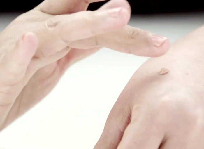 Dispense a small amount of foundation onto the back of your hand and apply five small dots of foundation with your fingertips onto your forehead, both cheeks, nose, and chin.