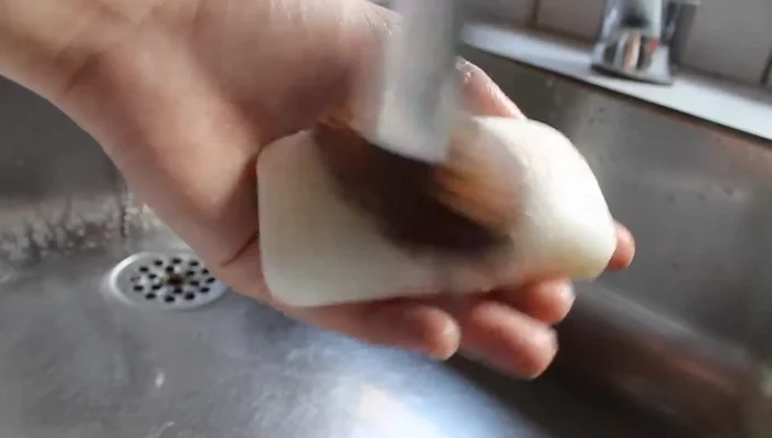 Swirl the brush on the lid.