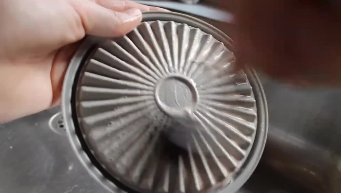 Swirl the brush on the lid and under running water.