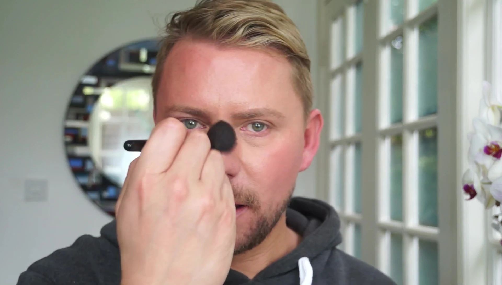 Applying bronzer to the bridge of the nose