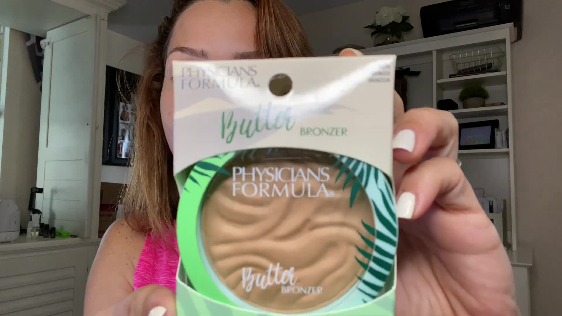 Close-up of the Physicians Formula Butter Bronzer packaging, showcasing the vibrant blue and green design.