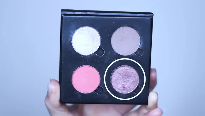 Apply contour shade with a smaller brush, tapping it onto the outer third of the lid. Blend with a clean blending brush to soften harsh lines.