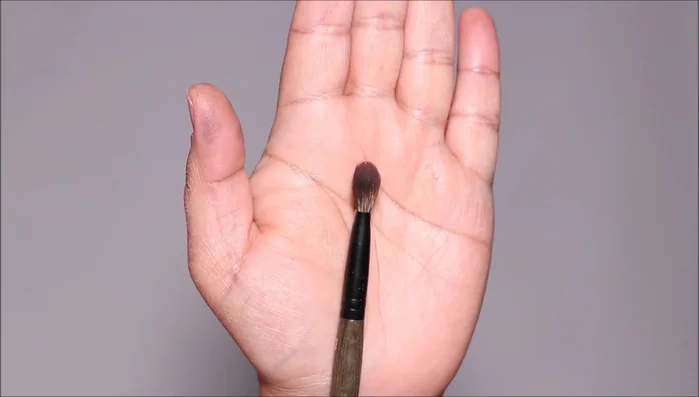 Apply the same darker shade to the lower lash line using a small angled brush, stamping it close to the lashes.