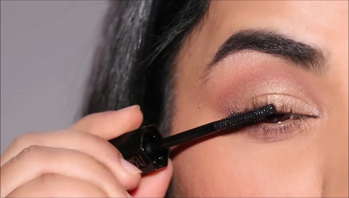 Apply blush and lipstick to complete the look.