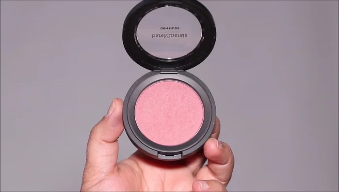 Apply blush and lipstick to complete the look.