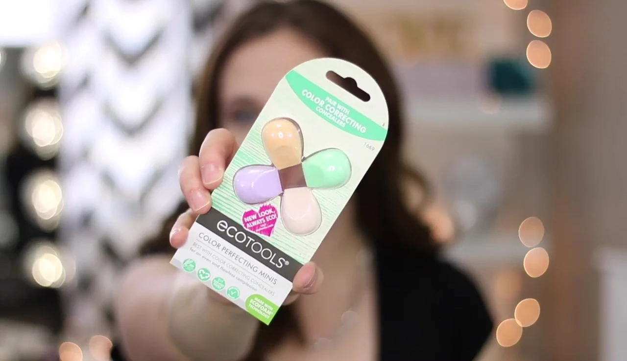 The reviewer holding the mini sponges, showing their small size.
