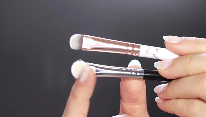 Use a fluffier flat brush to blend a contour shade (darker than your skin tone) around the edges of the black eyeshadow for a smooth fade. This also deepens the look.