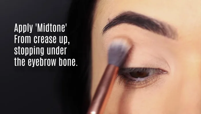 Apply the mid-tone shade in the crease, blending upwards towards the brow bone, leaving a gap under the brows. Keep your eyes open to ensure correct placement.
