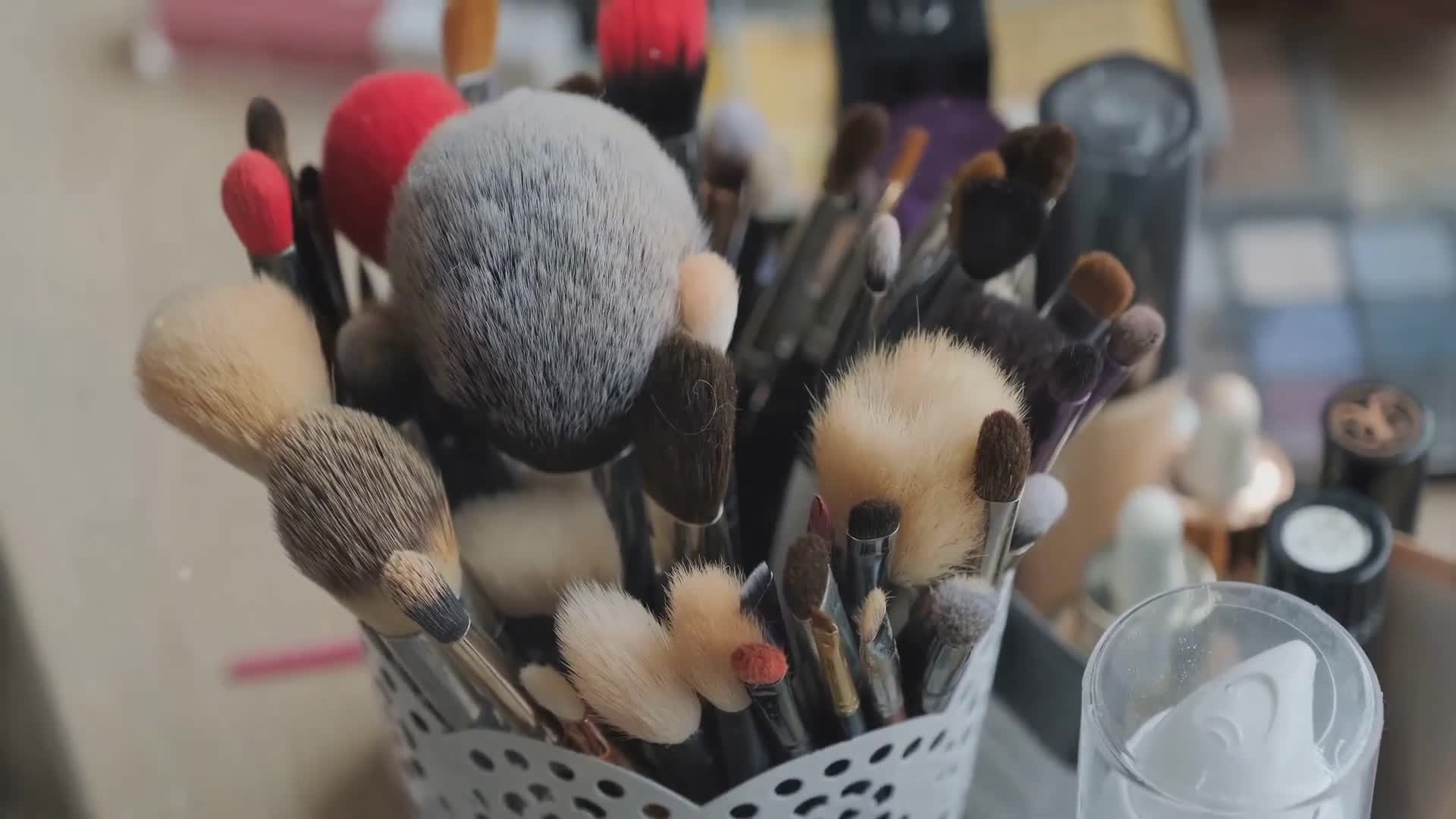 A shot showing a pile of dirty makeup brushes