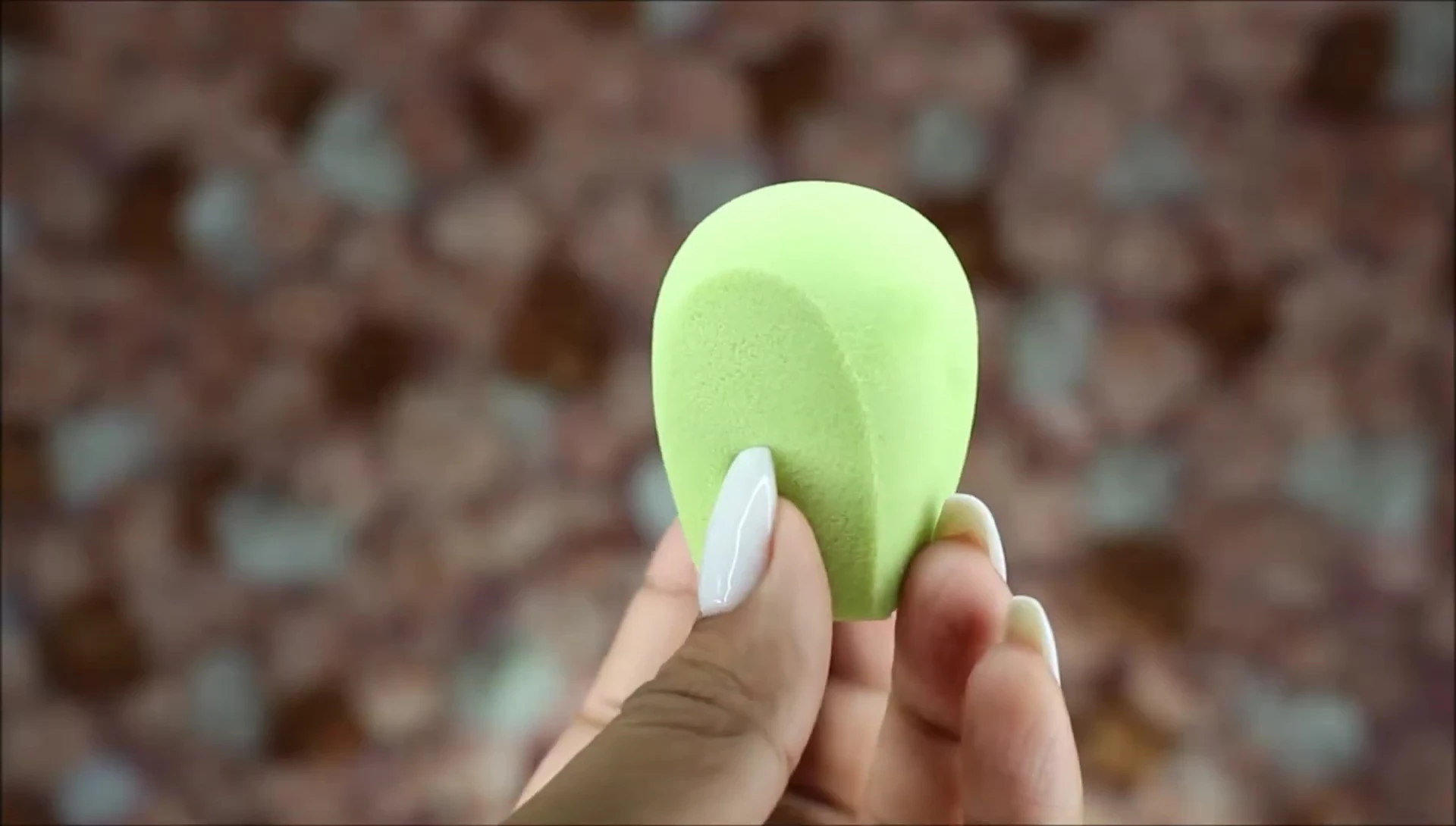 The smaller lime-yellow sponge, demonstrating its firmer texture.
