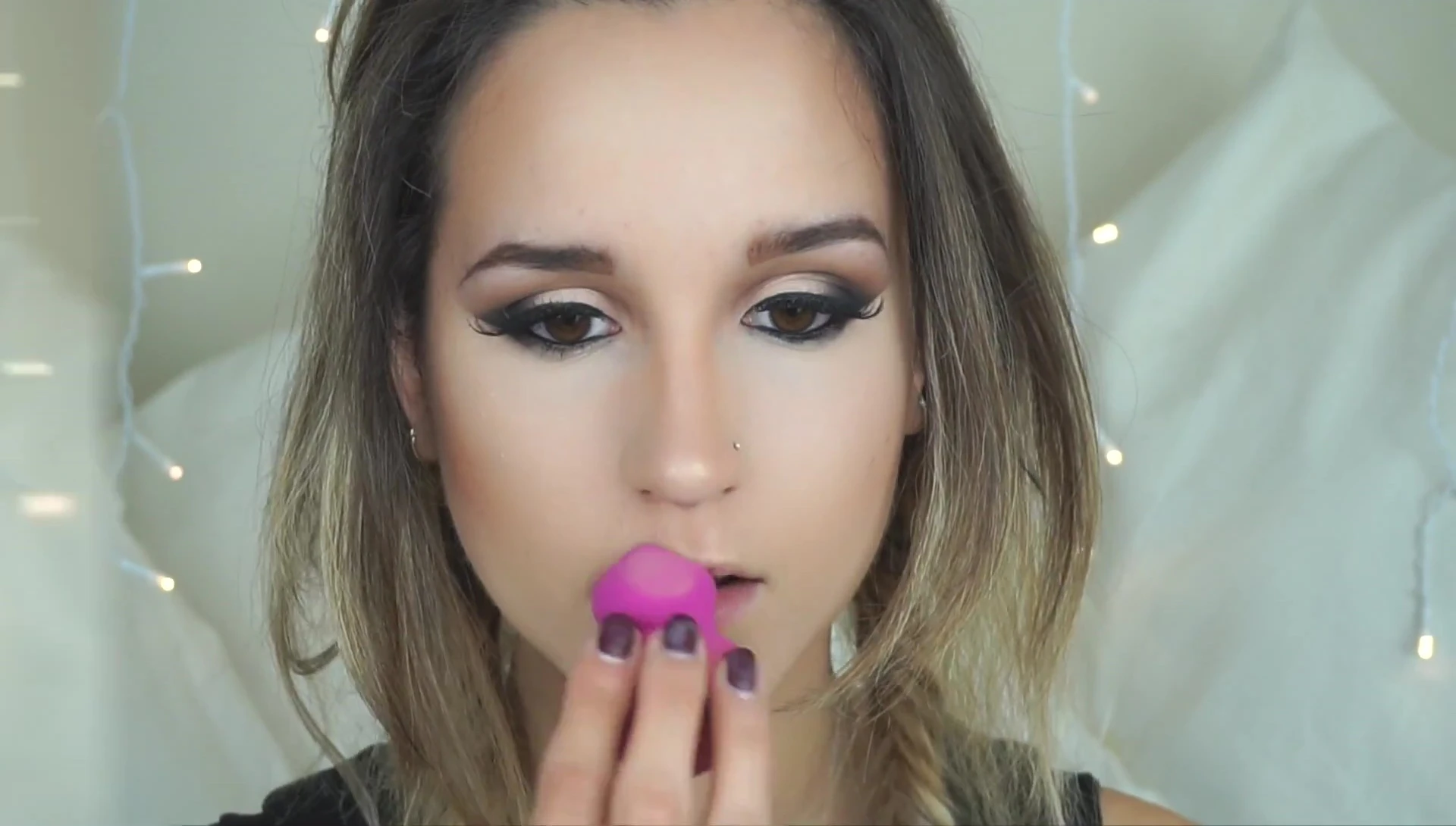 The blogger showcasing her completed makeup look.