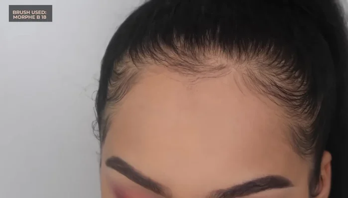 Apply a dark brown shade to the outer corner, blending it into the red for depth.