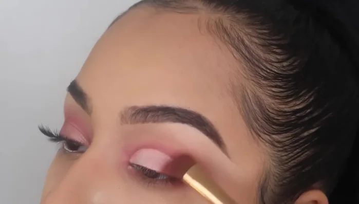 Blend purple and shimmery shades onto the cut crease.