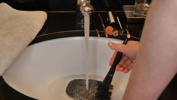 Squeeze out excess water: Gently squeeze the water out of the brushes to remove any remaining cleanser and makeup.