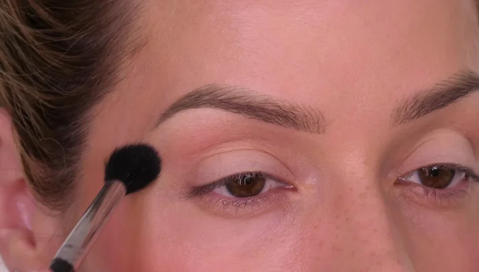 Apply a matte bronzer or brown eyeshadow above the eyelid crease and towards the brow bone, avoiding the lid space, to create a slight contrast and define the crease.