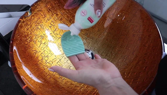 Rinse your brush with water to check for cleanliness. Repeat steps 2 and 3 until the soap is free of makeup color.