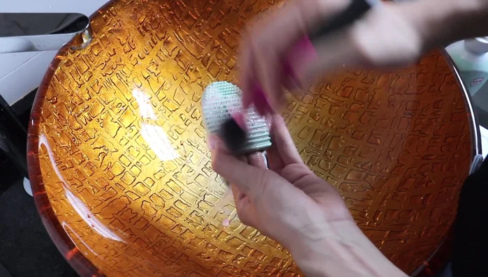 Rinse your brush with water to check for cleanliness. Repeat steps 2 and 3 until the soap is free of makeup color.