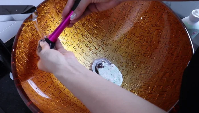 Rinse your brush with water to check for cleanliness. Repeat steps 2 and 3 until the soap is free of makeup color.